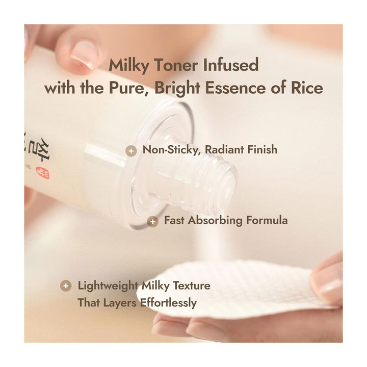 A close-up of a hand holding a clear bottle of toner and tilting it to pour a milky liquid onto a white cotton pad. Text overlays describe the toner as milky and infused with rice essence, with additional benefits listed.