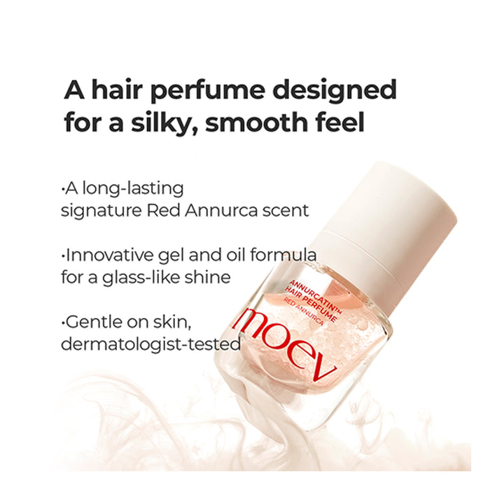 A bottle of Moev hair perfume with a white cap and clear glass bottle showing a pinkish liquid, set against a white background with marketing text describing a silky, smooth feel and Red Annurca scent.
