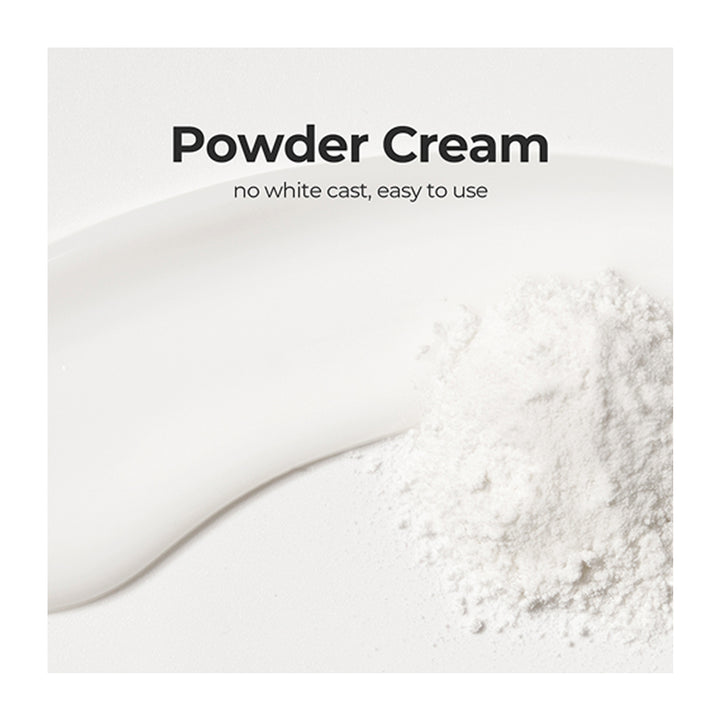 White powder cream shown as a smooth creamy streak on a white surface with a small pile of loose powder, captioned &