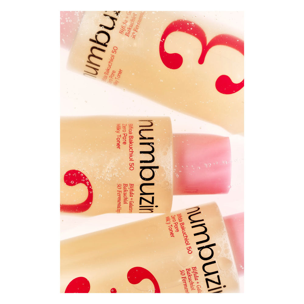 Three tubes of Numbuzin skin beauty gel arranged diagonally on a white background with a light pink liquid visible at the caps.