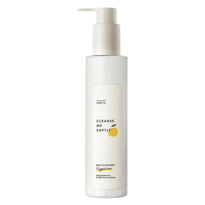 A tall white bottle of Siofs Cleanse Me Softly milk cleanser with a pump dispenser, featuring a minimalist label with a small yellow citrus graphic, on a solid white background.