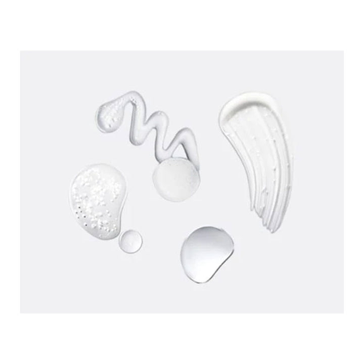 White cosmetic product swatches on a light gray background