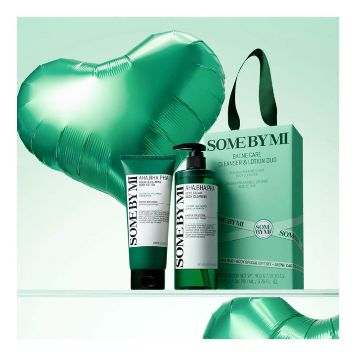 SOME BY MI AHA-BIOTA PHO Cleanse &amp; Lotion Duo gift set, featuring a green and white cleanser bottle, a green and white lotion tube, a matching green gift bag, and a large metallic green heart-shaped balloon against a mint green background.