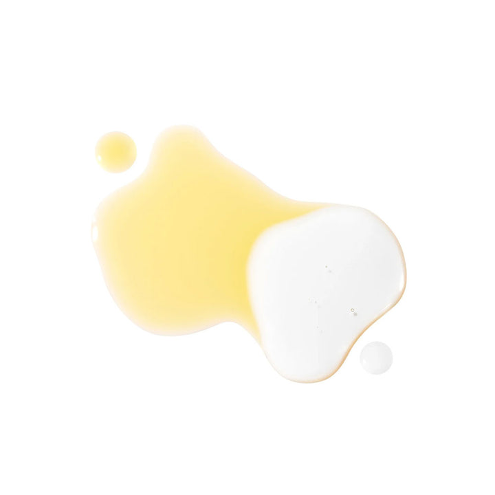 Two paint splashes, one yellow and one white, on a white background