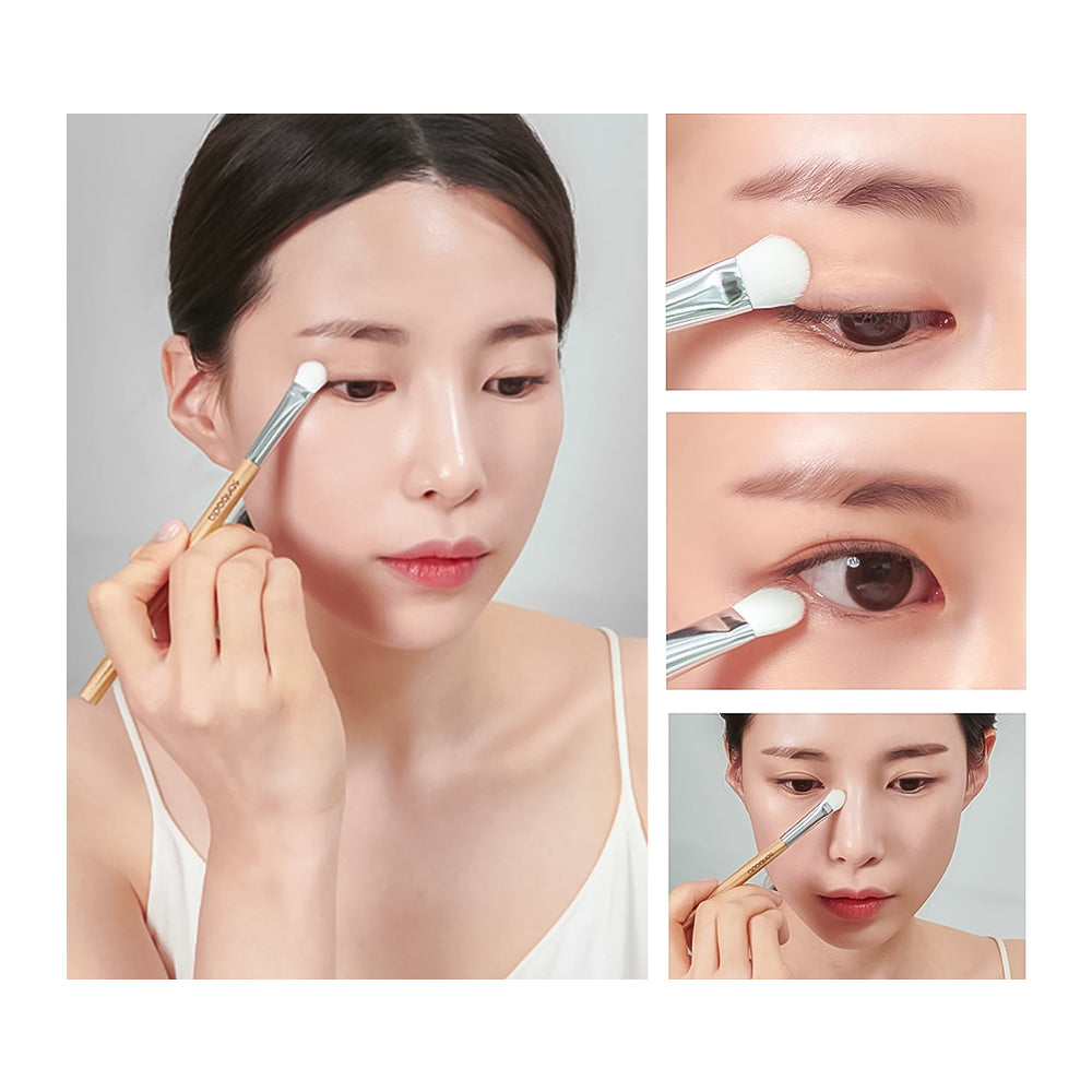 A makeup brush being used on a woman&