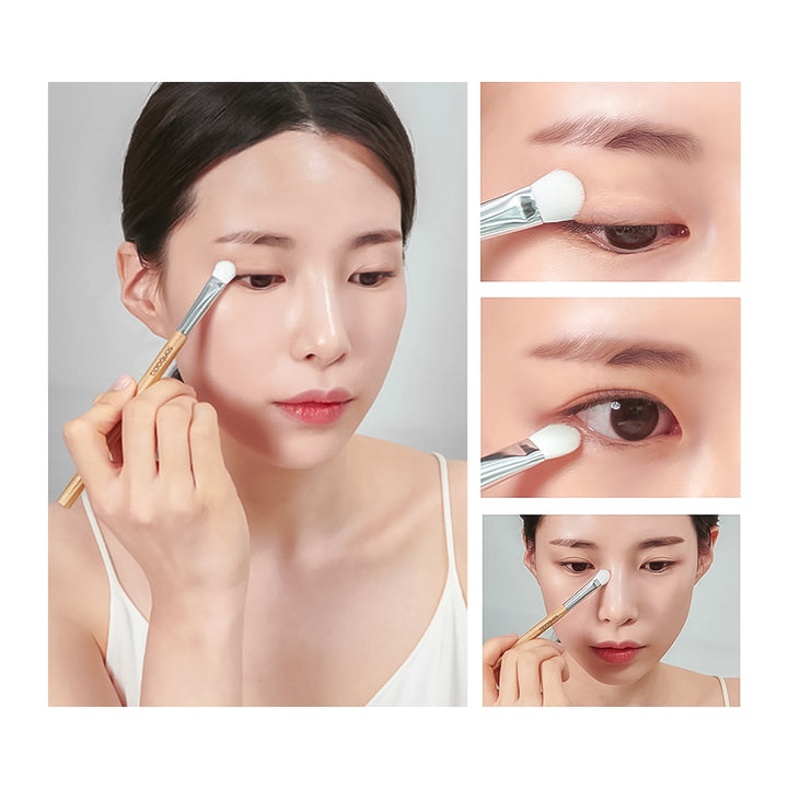 A makeup brush being used on a woman&
