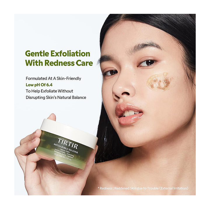A woman holds a jar of TIRTIR Gentle Exfoliating Redness Care Peachy Sugar Scrub against a clean white background with product text. The woman has a small amount of the scrub applied to her cheek.