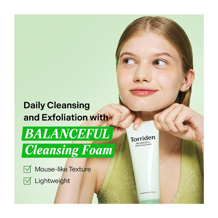 A woman holding a tube of Torriden Balancing Cleansing Foam against a light green background with promotional text about daily cleansing and exfoliation.