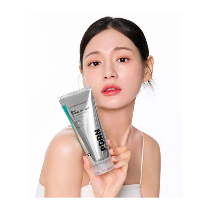 A woman holding a silver tube of BUNN hair product against a clean white background.