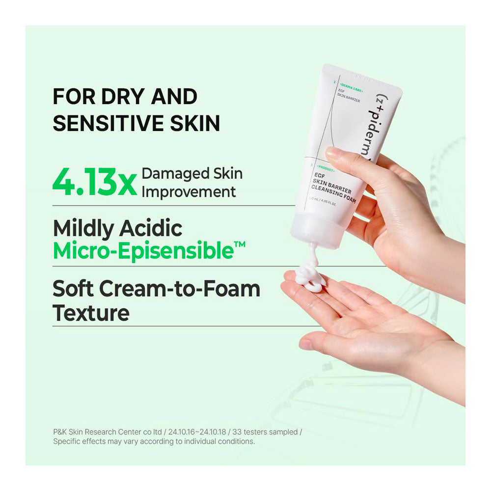 A hand holds a white tube of Spidera Skin Barrier Cleansing Foam while squeezing cream onto another hand, set against a pale mint green background with promotional text about dry and sensitive skin benefits.
