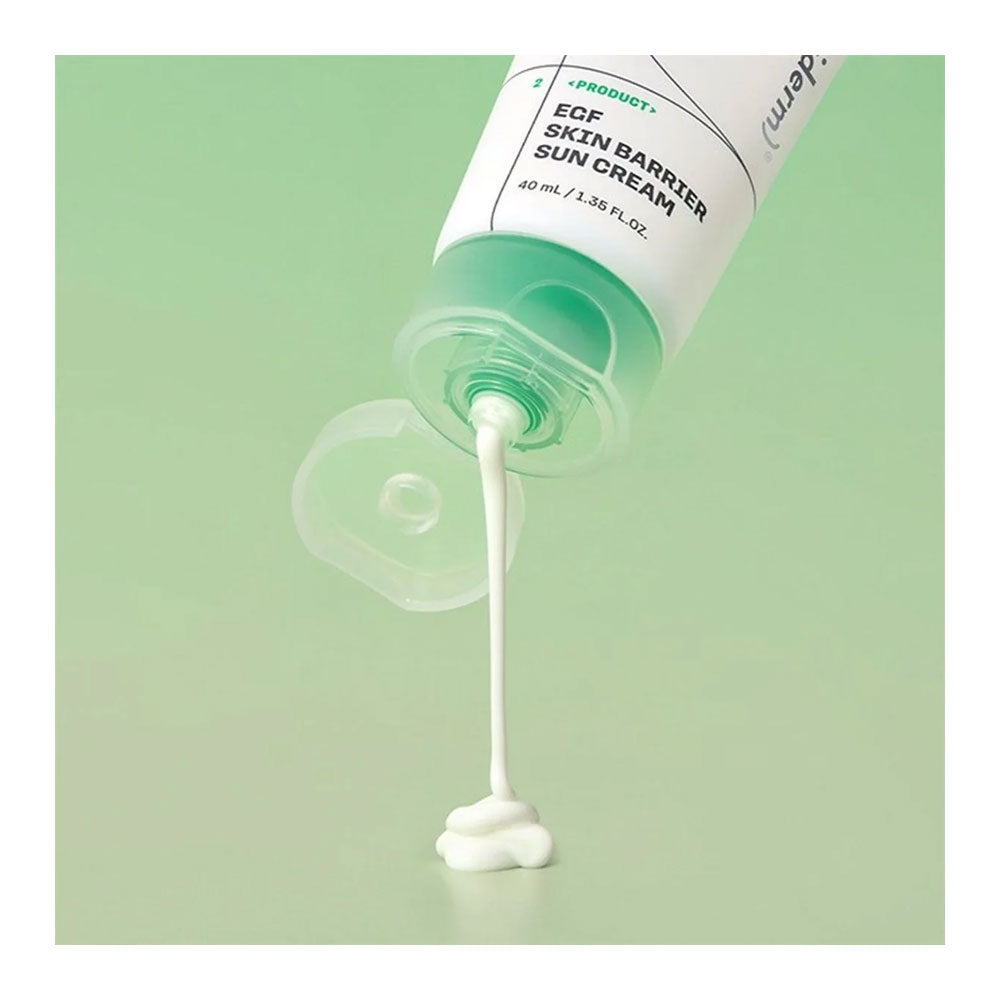 A tube of EEF Skin Barrier Sun Cream is shown tilted on a light green background, with white cream dripping from the clear cap into a small pile below.