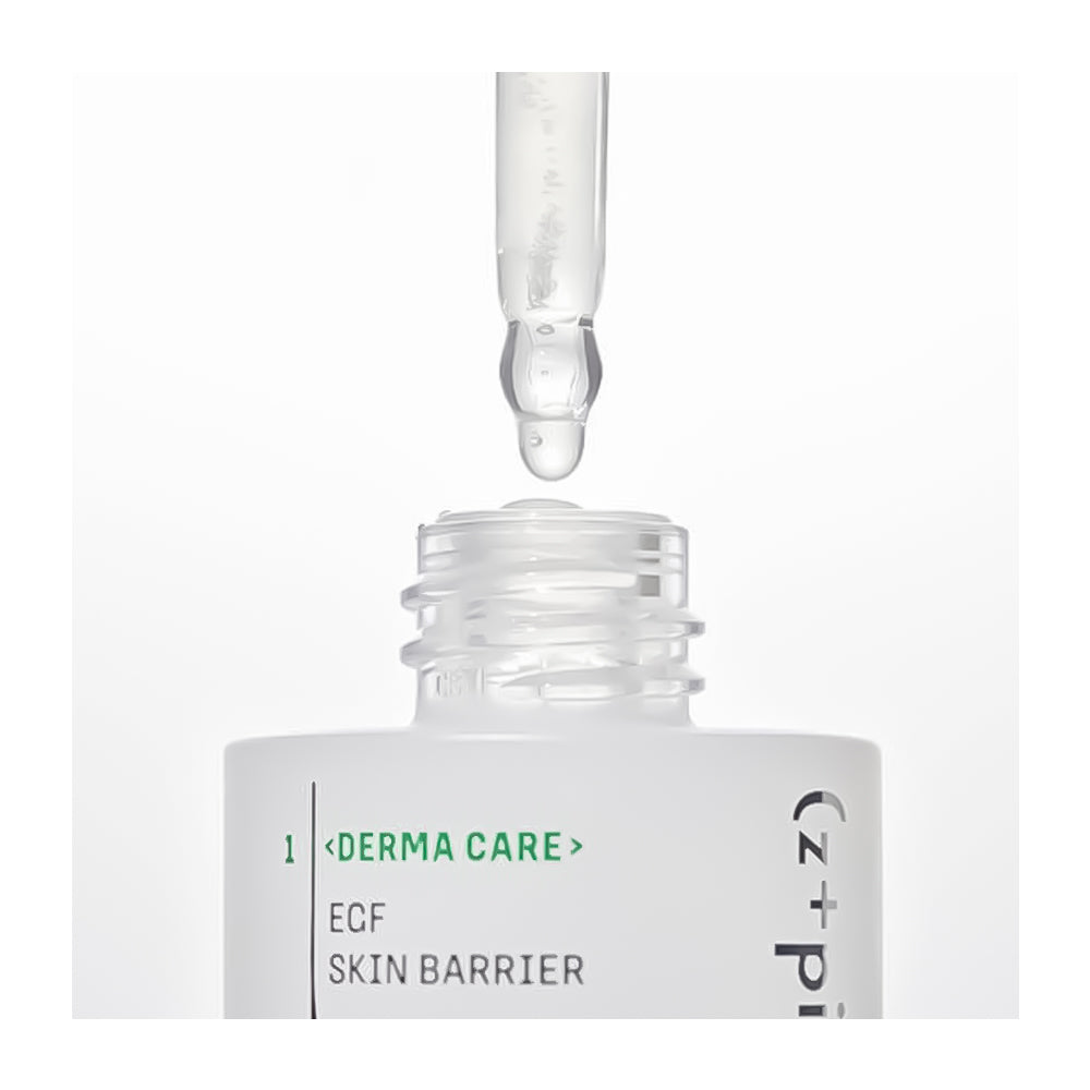 A close-up of a skincare dropper bottle with a clear glass pipette above the open bottle, showing a clear serum drop. The label reads &